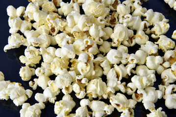 delicious popcorn dropped on corn grain table with copy space