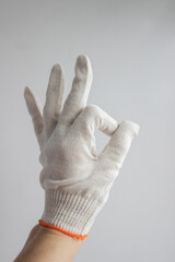 A hand in a white glove on a white background shows the 
