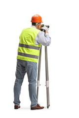 Rear view of a geodetic surveyor using a measuring instrument