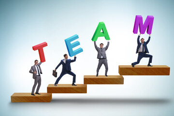 Teamwork concept with people carrying team letters