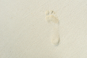 Lonely footprint in the sand. Blurred human footprint in the sand. The texture of the sand.