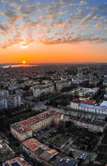 Cityscape from above. Sunset with dramatic clouds with drone