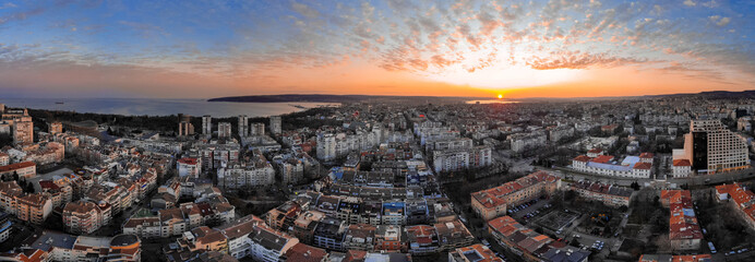 Cityscape from above. Sunset with dramatic clouds with drone