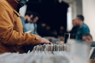 Man hands browsing vinyl album in a record store