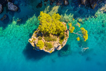 Mediterranean sea. Aerial view on the beach and rocks. Top view from drone at beach and azure sea. Travel and vacation image from air.