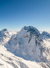 Mountain peak covered with snow under a clear sky 