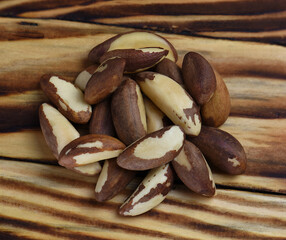 Brazil nuts pile on wooden background.