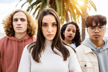 Portrait of unhappy millennial group of young people - United serious millennial student friends standing in street looking serious at camera - Powered by Adobe