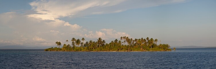 Panorama of sunny and idyllic San Blas Islands with palm trees and no people making a deserted island paradise between Colombia and Panama.