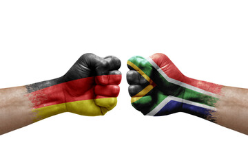 Two hands punch to each others on white background. Country flags painted fists, conflict crisis concept between germany and south africa