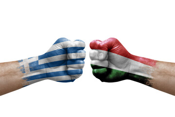 Two hands punch to each others on white background. Country flags painted fists, conflict crisis concept between greece and hungary