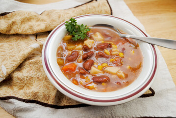 Vegan Garden Vegetable Soup Served in a White Bowl	