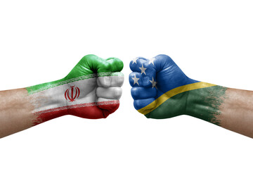Two hands punch to each others on white background. Country flags painted fists, conflict crisis concept between iran and solomon islands