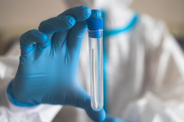 Process of coronavirus PCR antigen testing examination by nurse medic in laboratory lab, COVID-19 swab collection kit, test tube for taking OP NP patient specimen sample, patient receiving test © tsuguliev