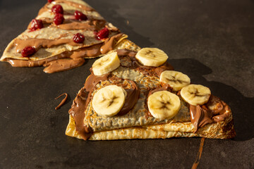 European pancakes with chocolate cream, cherries and bananas