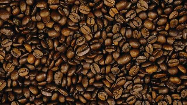 The coffee beans on the turntable. The coffee beans spin rotate. Twist, create pattern, make design picture.