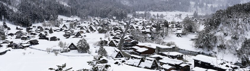 Shirakawago, Japan - February 24, 2022 : Panoramic view of Snow-covered Shirakawago village in winter recorded on February 24, 2022. Beautiful Traditional houses (thatched roof or gassho-zukuri). Shir