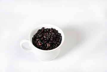 Fototapeta na wymiar white cup with roasted coffee beans isolated with copy space