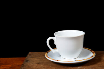 white cup with roasted coffee beans isolated with copy space