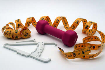 dumbbell tape measure and body fat caliper