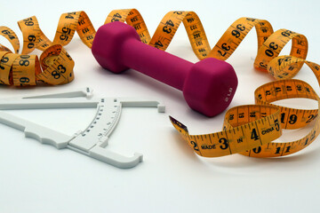 dumbbell tape measure and body fat caliper