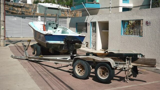unused boat on its trailer out of season. Parking near city road. High quality 4k footage