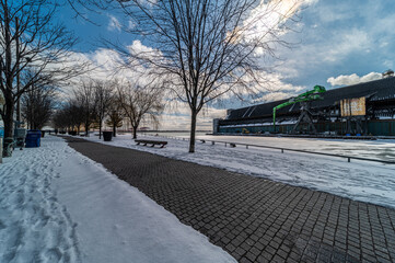  Sugar Beach park down town Toronto with Pink Umbrellas Blue cloudy skies and snow on the ground and beach chairs