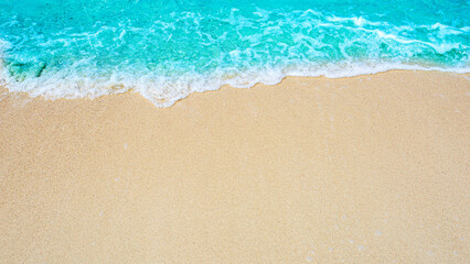 Summer beach background / sea wave on the sand for a space for you to enter text..