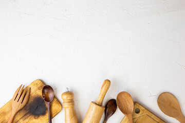 Wooden table, white kitchen set and cooking equipment / Top view with copy space for your.