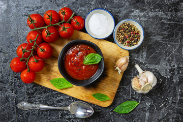 Tomato sauce in bowl On a black background /Top view flat lay with copy space