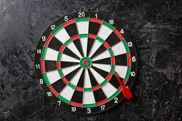 Business goals / dartboard on the black wall. Pan placement. Business success and conceptual management.