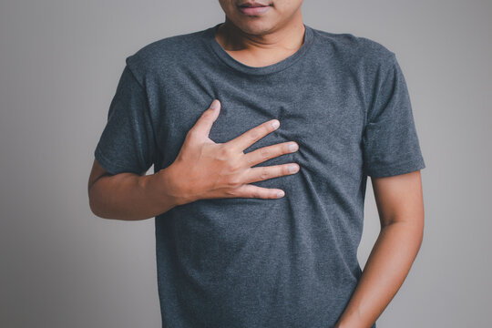 Men Have Symptoms Of Burning Sensation In The Middle Of The Chest Caused By Acid Reflux. /Health And Medical Concepts.