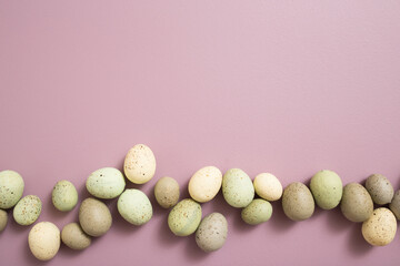 Easter Eggs on Purple Pastel Background with White Space