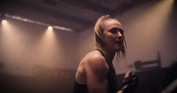 A Strong Man And Woman Sparring / Training In A Martial Arts Gym. Shot In A Crossfit Boxing Gym With Low Key Lighting And A Scattering Of Haze. Captured On Red Digital Cinema Camera 