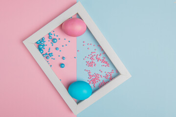 on a colored background, blue and pink Easter eggs in a white frame