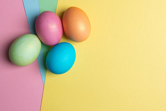 several colored eggs lie on colored backgrounds