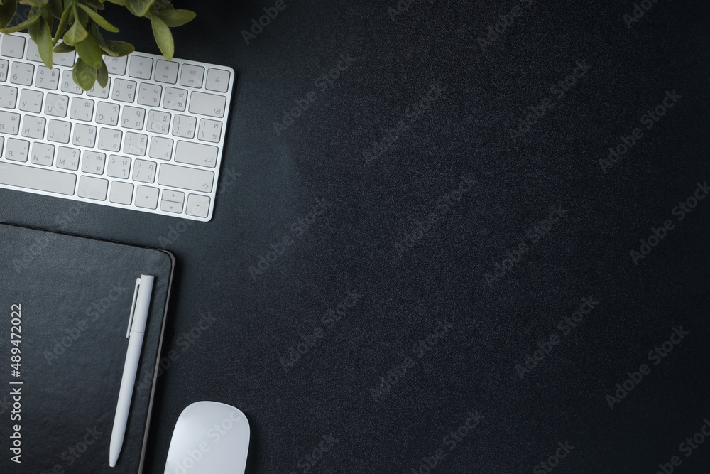 Aufkleber top view working desk with keyboard mouse and notebook on black table background
