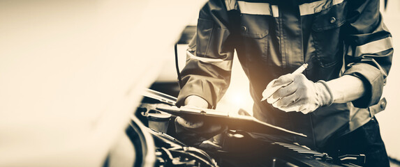 Car care maintenance and servicing, Close-up hand technician auto mechanic checking inspection list...