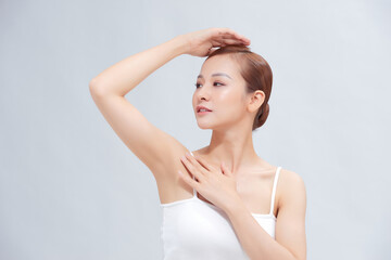 Beautiful Young Asian woman lifting hands up to show smooth armpit cleanliness and protection concept - obrazy, fototapety, plakaty