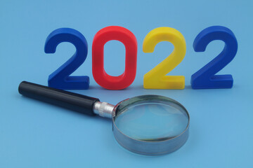 Review future events in year 2022 concept. Magnifying glass and numbers 2022.