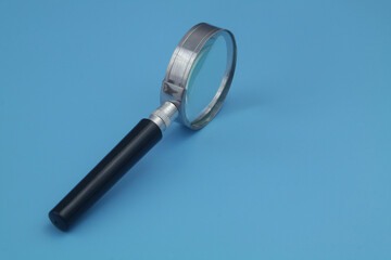 Magnifying glass on blue background	