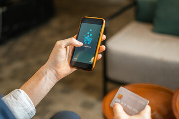 Businessman shopping online on mobile phone, payment by credit card, wear suit, sitting in hotel cafe, focus mobile phone. Young man and woman work business or shopping online in hotel cafe