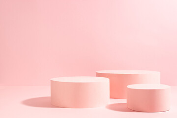 Bright pastel pink three different circle podiums in sunlight with shadow mockup for presentation cosmetic product or goods, copy space. Romantic template for advertising, design, show, display.