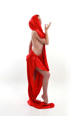 Full length portrait of red haired woman wearing a  beautiful sexy silk gown costume, standing pose...