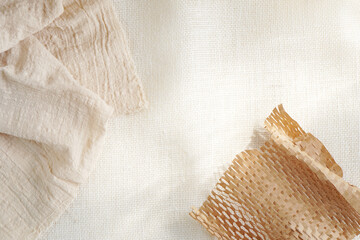 top view in flat lay style of table setting mock up with linen cloth and decor brown paper with copy space. beige minimalist background for wallpaper, design, lettering, cards, blogs, banner or poster