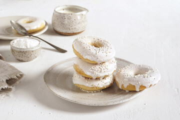 Homemade sugar dusted donut in ceramic plate and gravy boats in the white background, selective focus, copy space