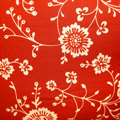 Red fabric with flower patterns closed up