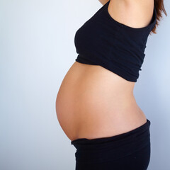 Proud of what my husband and I created. Side angle view of pregnant womanamp039s stomach.