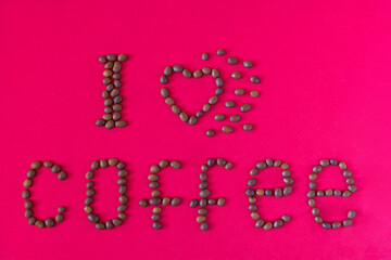 I love coffee. Romantic composition with coffee beans on a red background