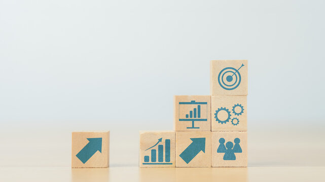 stacking wooden cube with improvement icon standing with goal. plan, action, and improvement concept.